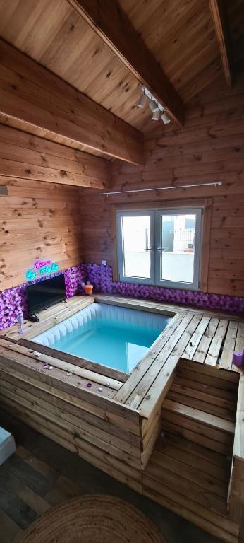 a large swimming pool in a wooden building at Flyby pole studio in Béziers