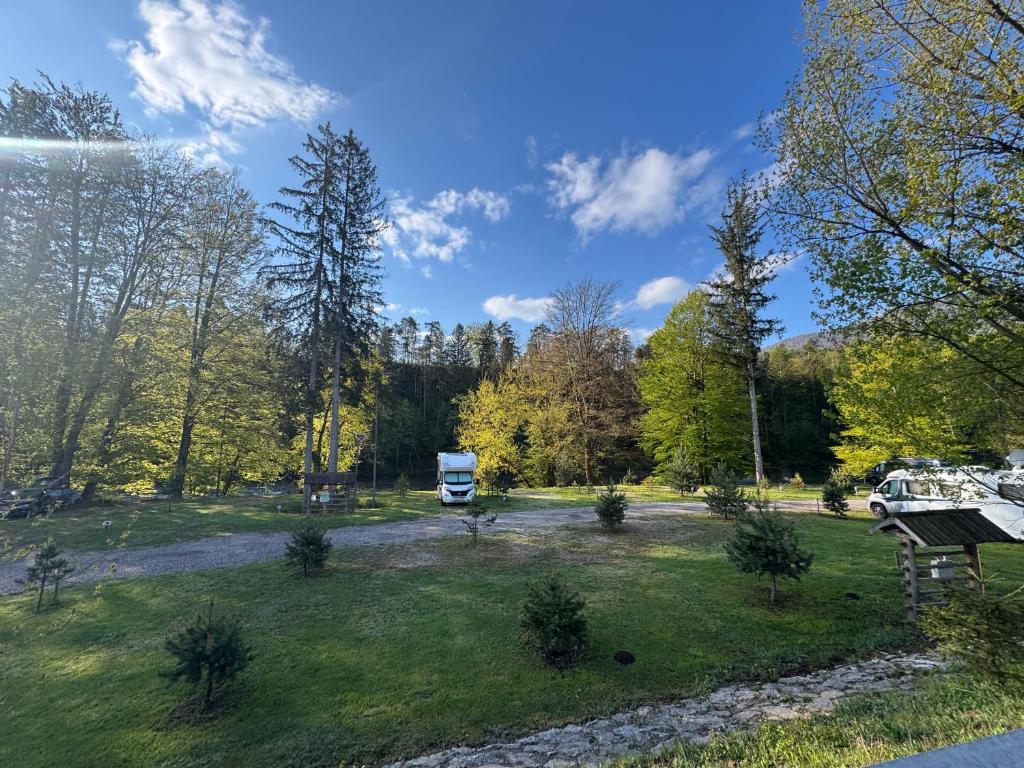 a park with a truck parked in a field at Tinaraft camp in Radovljica