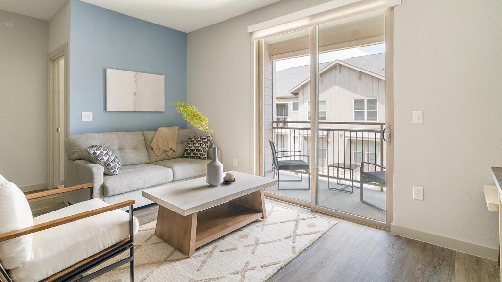 a living room with a couch and a table at Landing Incredible 2BD Gym in New Caney