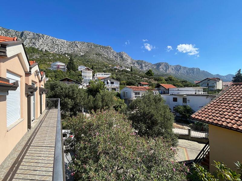 a view of a city with houses and mountains at sunny Podaca in Podaca