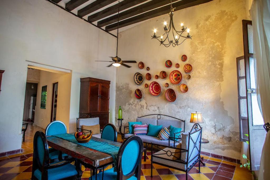 a dining room with a table and blue chairs at Historical Green House Campeche in Campeche