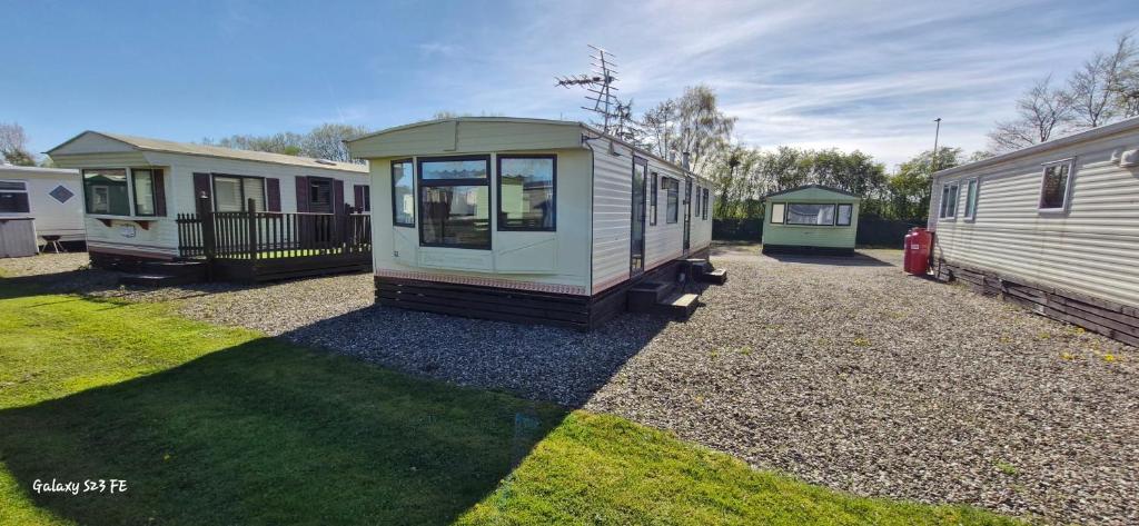 a tiny house sitting on top of a gravel yard at No 21 The Tummel in Forfar