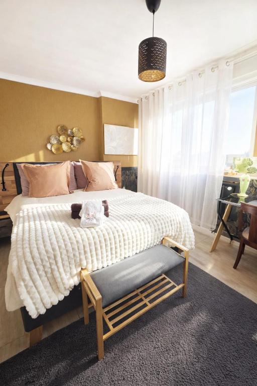 a bedroom with a bed with a teddy bear on it at Chambres d'hotes la forêt in Longwy