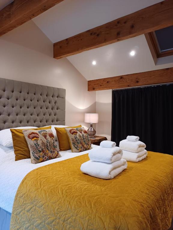 a bedroom with a large bed with towels on it at south view farm cottage 1 Bed in Bradford