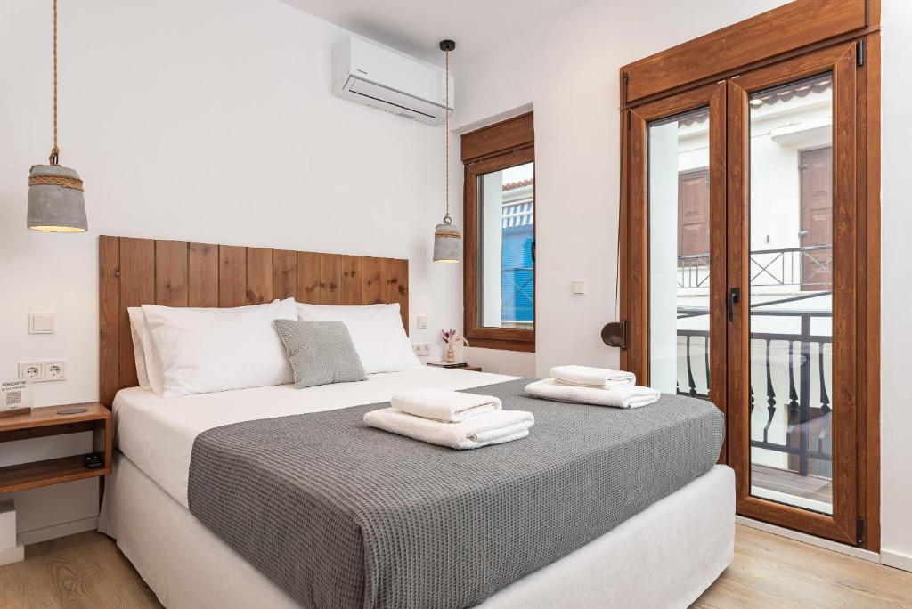 a bedroom with a bed with two towels on it at Kalami in Kokkari