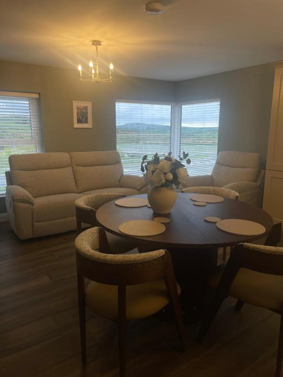 a living room with a table and a couch at Anna and Jims Cottage in Claudy