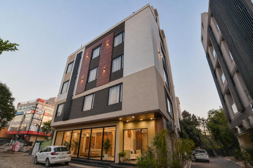 a building with a car parked in front of it at Aceotel Select Virat, Vijay Nagar in Indore