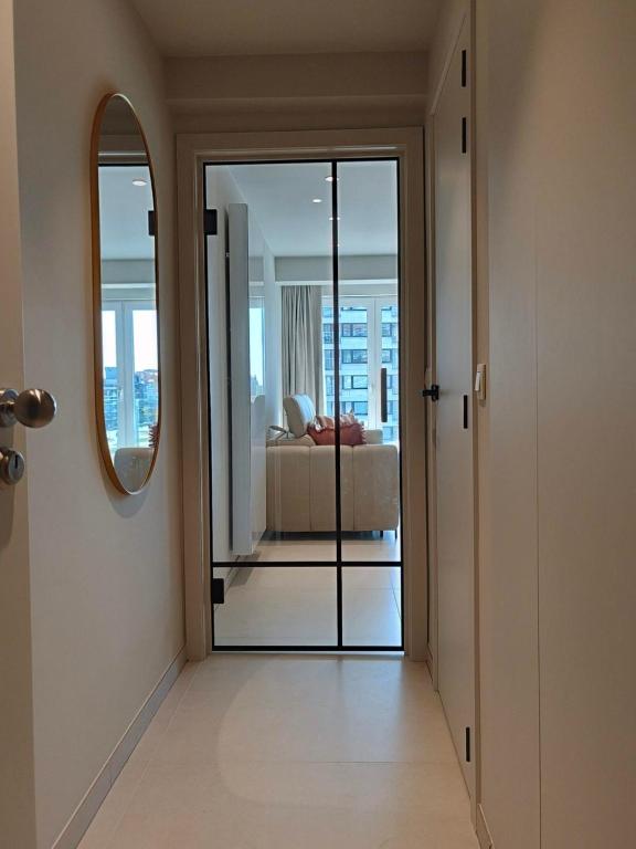 a hallway with a door leading to a living room at Studio met zeezicht op Heldenplein in Knokke-Heist