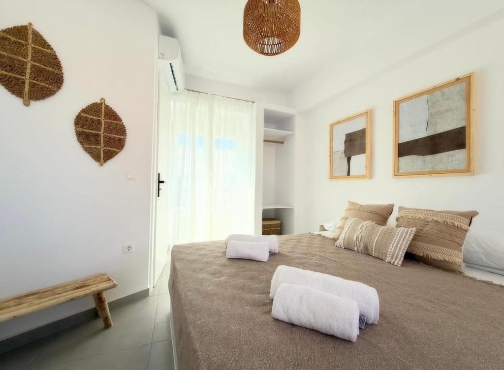 a bedroom with a large bed with two white pillows at K&M studio in Naxos Chora