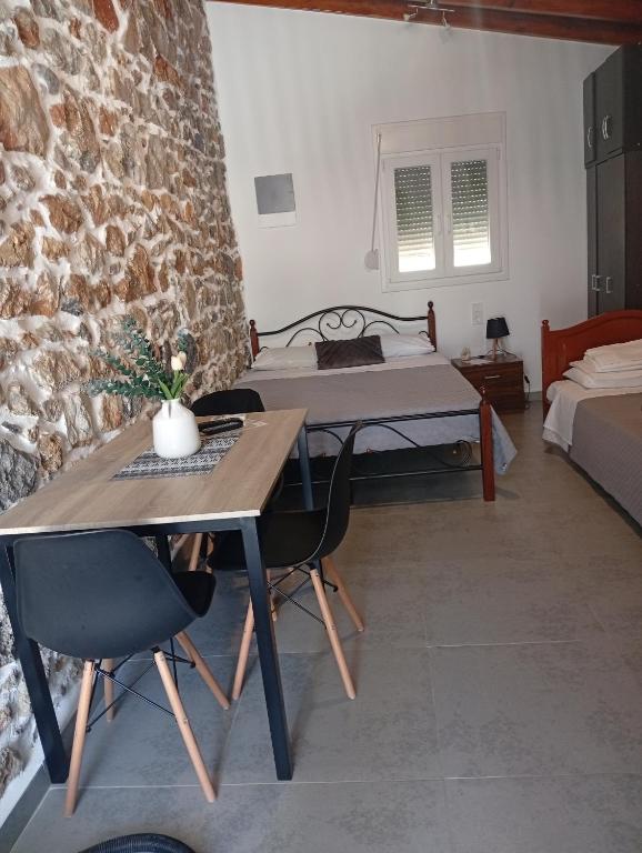 a room with a bed and a table and chairs at Markos House 2 in Kalymnos