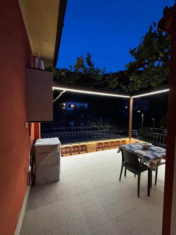 a table and a chair on a patio at night at Il Vigneto in Le Grazie