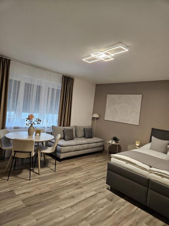 a living room with a bed and a table at Stadtoase Wels III in Wels