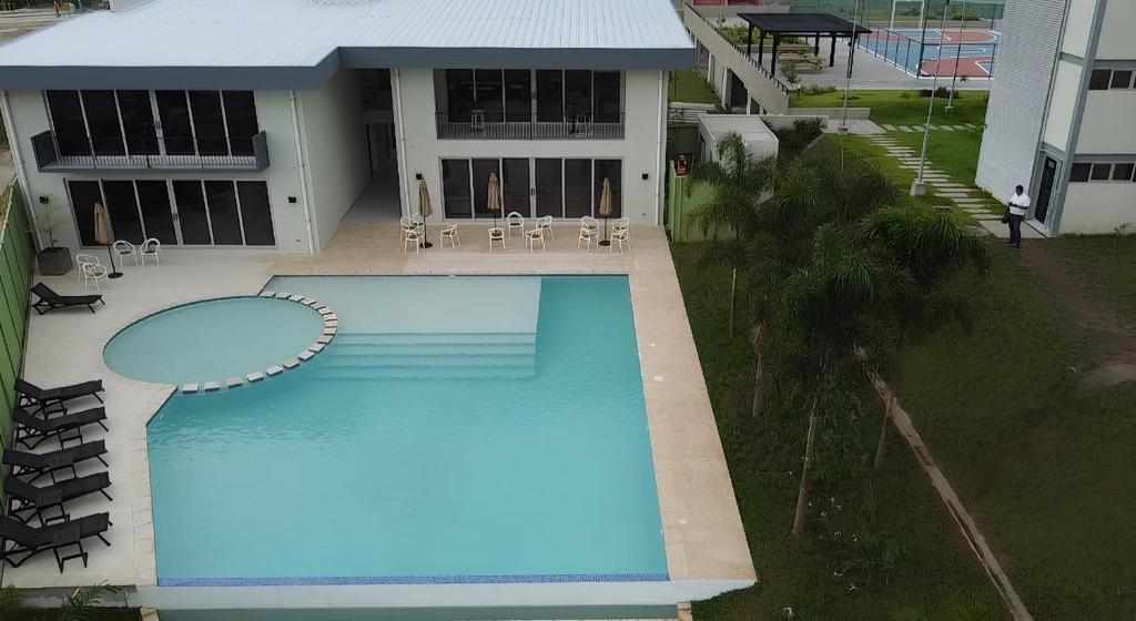 an overhead view of a swimming pool in front of a house at Modern top floor apartment with pool in San Marcos