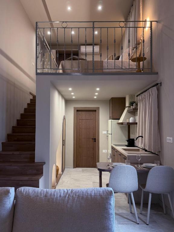 a kitchen and a living room with a table and chairs at A Casa Di Zoi in Archangelos