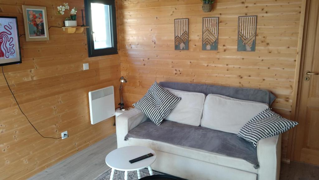 a living room with a couch and a table at L'Insolite in Melun