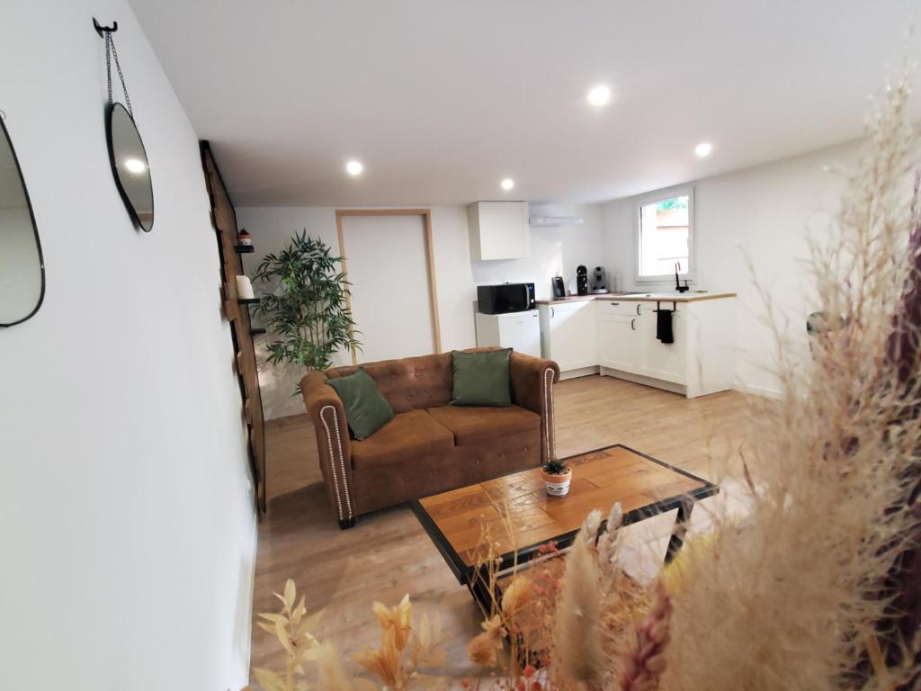 a living room with a couch and a table at Appartement - Cestas in Cestas