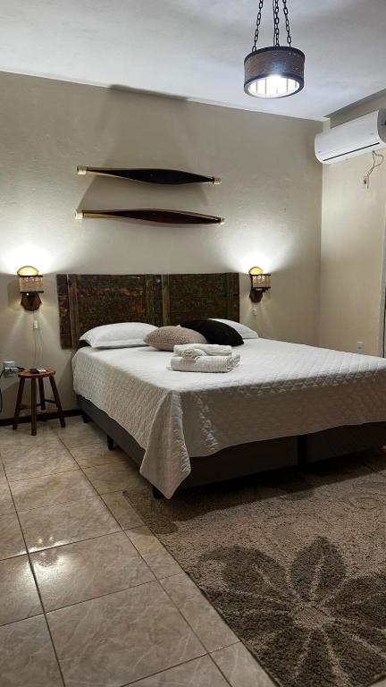 a bedroom with a large bed in a room at Refúgio Aroma do Campo in Bagé