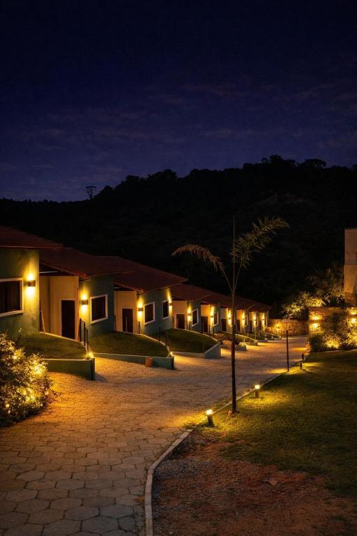 a row of houses at night with lights at Pousada real chalés in Belo Vale
