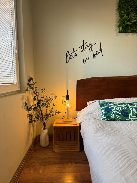 a bedroom with a bed with a sign on the wall at Apartments Veljanov - Sofra in Negotino