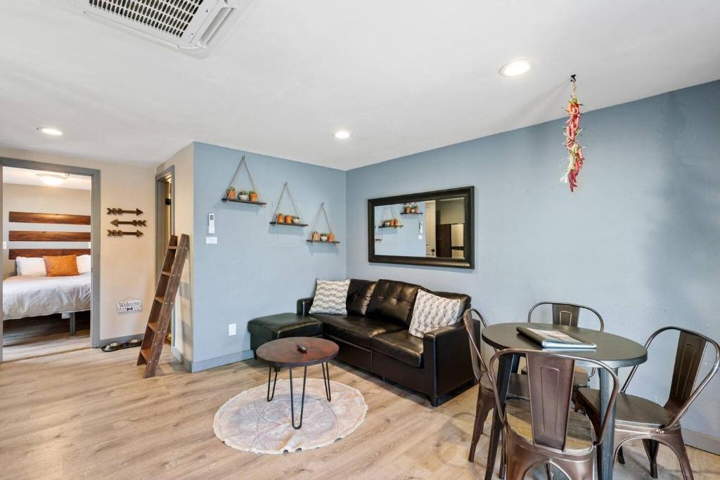 a living room with a couch and a table at Modern Pet-Friendly Cottage - Graystone Retreat in Prescott