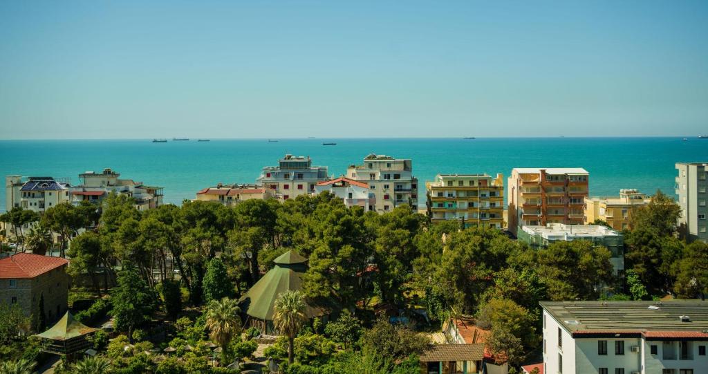 a city with buildings and the ocean in the background at Xhejn's Veranda 7 in Durrës