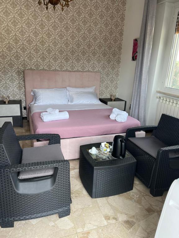 a bedroom with a bed with chairs and a table at Daar Meryem - Bed & Breakfast in Dego