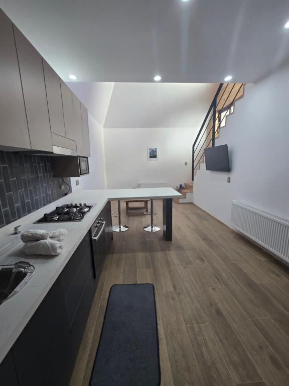 a kitchen with a table and a counter top at Palguin pad loft # 1 in Pucón