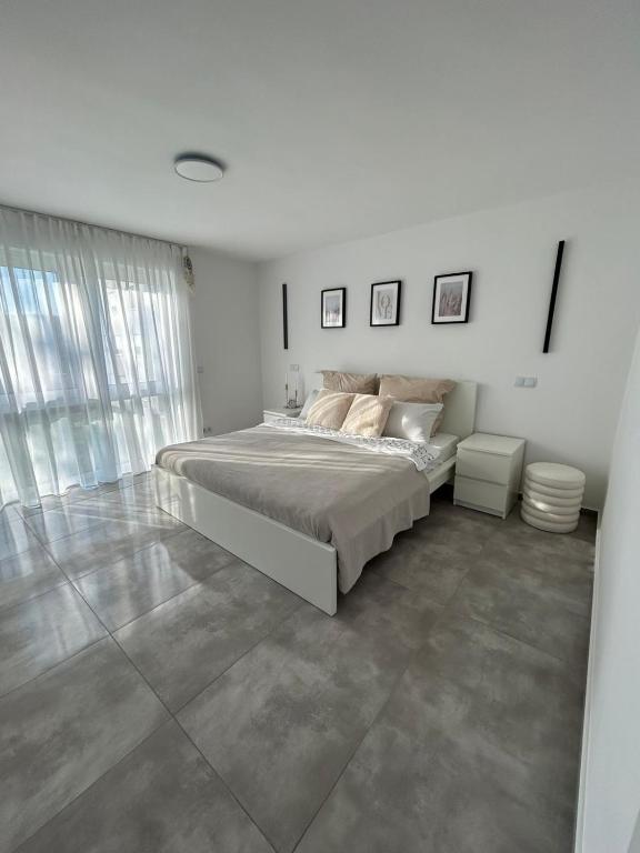 a white bedroom with a large bed in it at MelSun Apartment in Melsungen