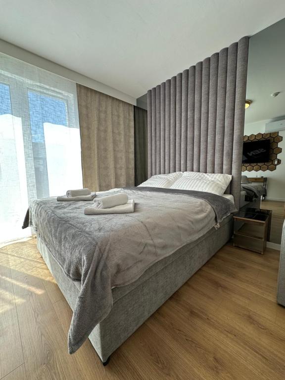a bedroom with a large bed with two towels on it at LUXURY Portovo in Gdańsk