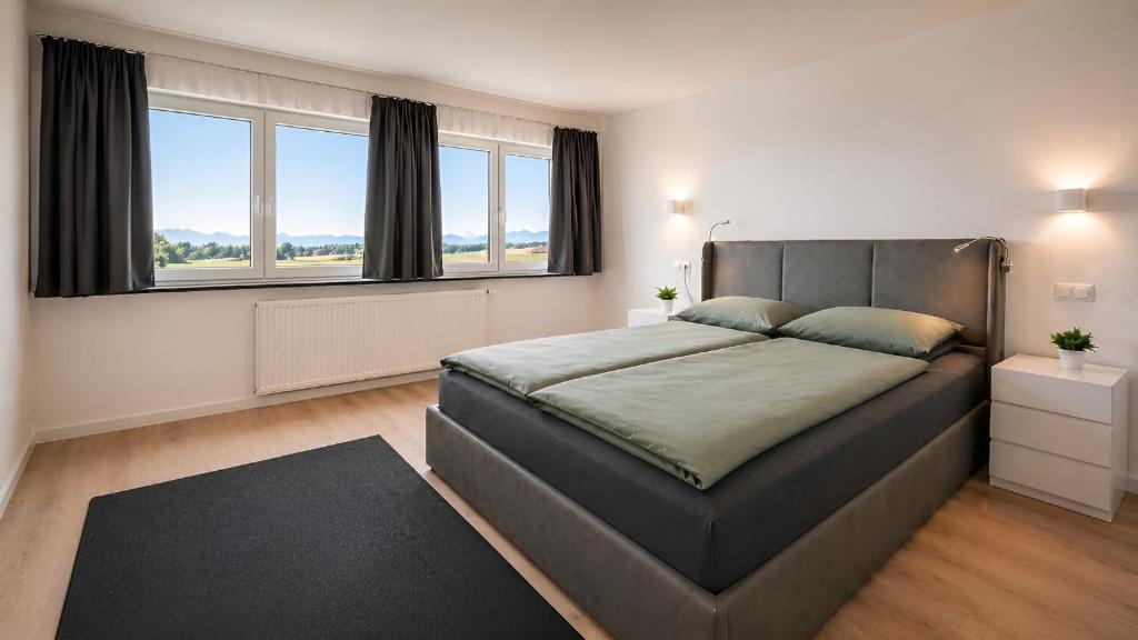 a bedroom with a large bed and a large window at Apollo Home - Im Zentrum der Natur in Wildflecken