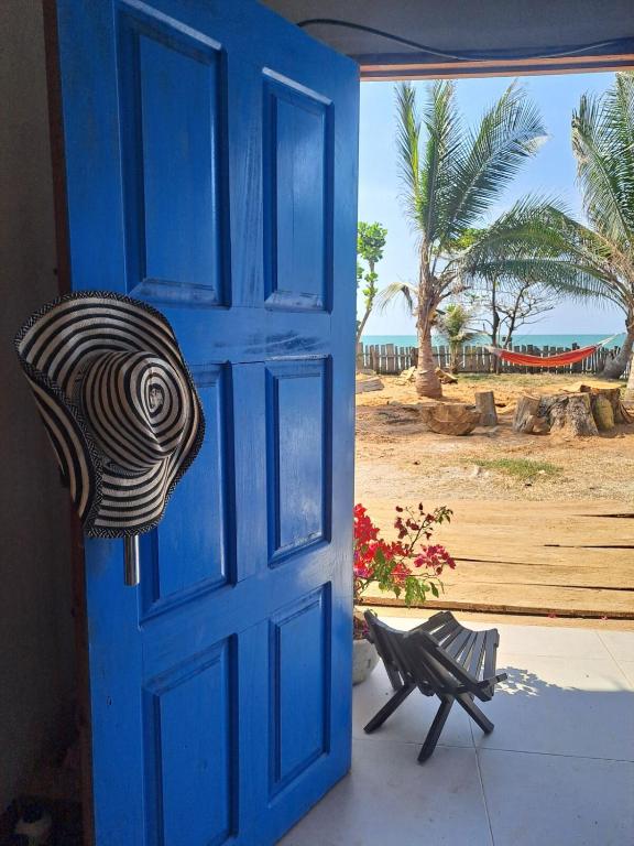 an open blue door with a view of the beach at Playa VICTORIA in Arboletes