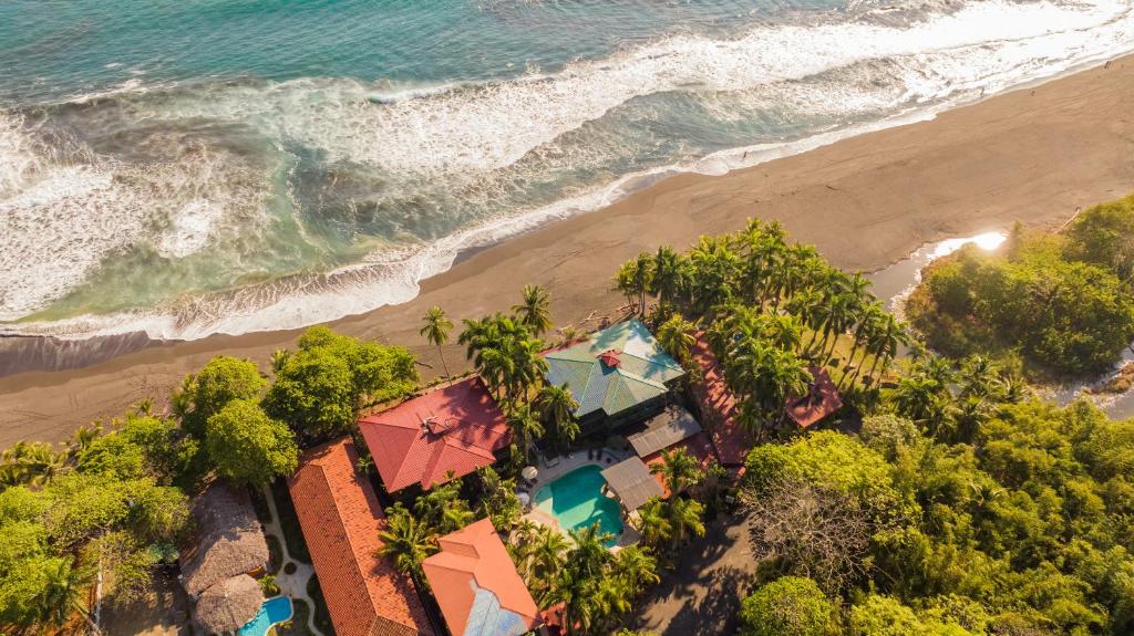 an aerial view of a resort on the beach at Host Company Jaco Luxury in Jacó