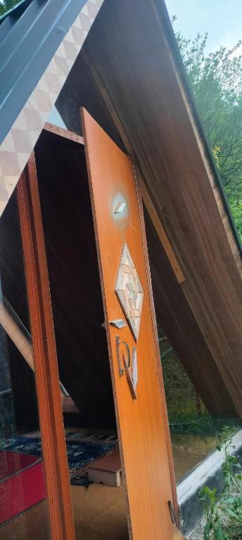 a wooden door with a handle in a house at Ambar Cottage in Kullu Manali