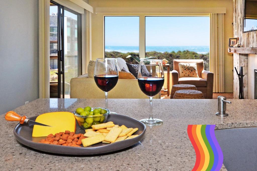 a tray of cheese and wine glasses on a counter at A Total Distanced Coastal Experience! in Watsonville