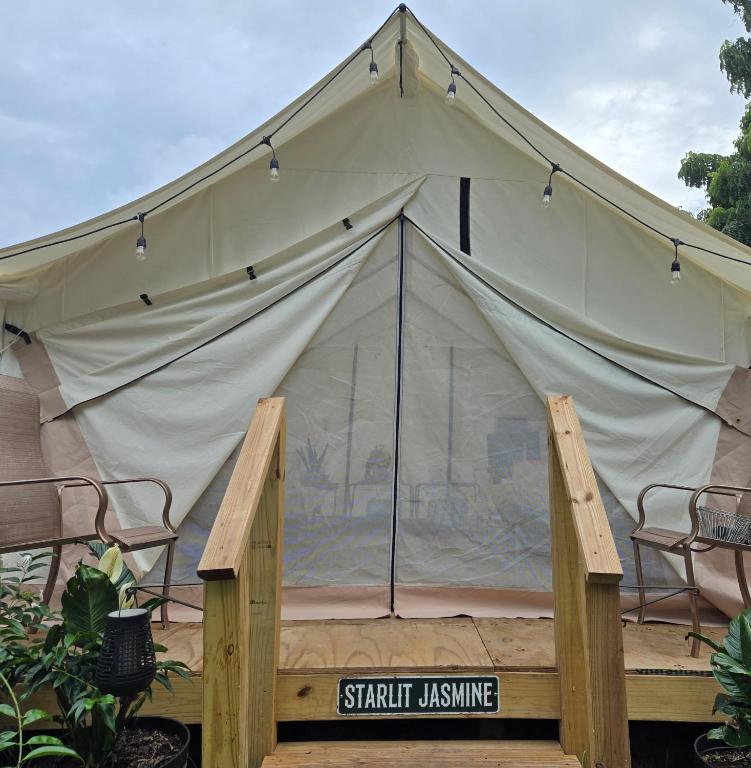 a large tent with chairs and a sign in front at Starlit Jasmine in Christiansted