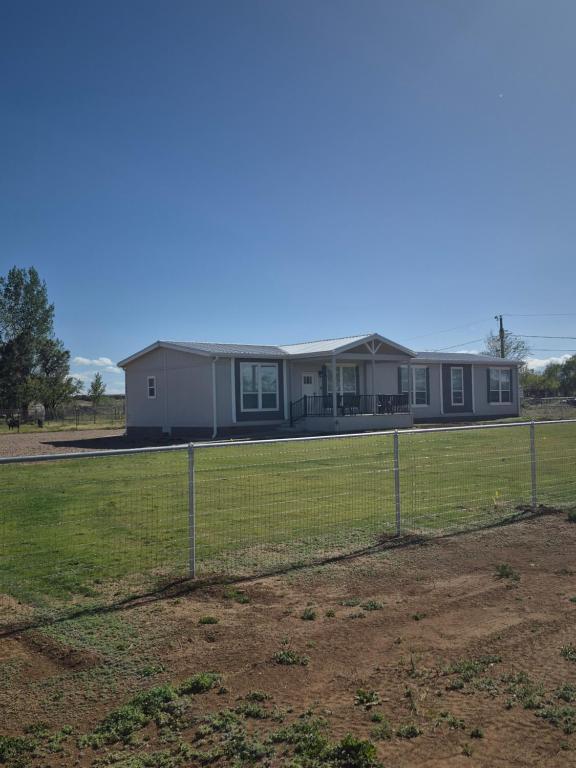 a house behind a fence in a field at Rural Farmhouse in Taylor