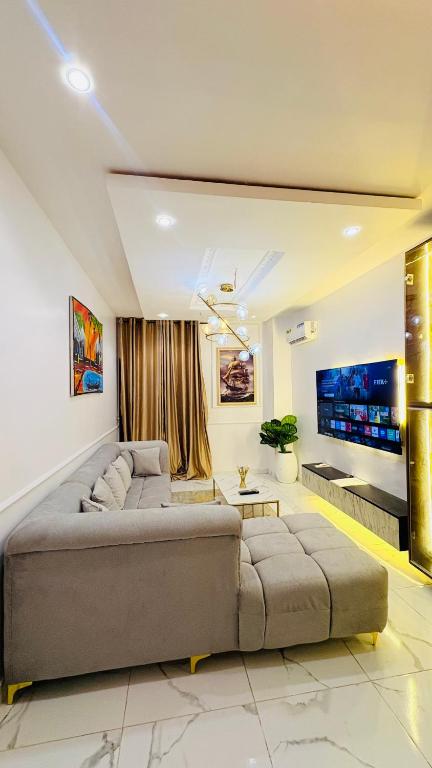 a living room with a couch and a tv at Candy horizon height homes in Ikate