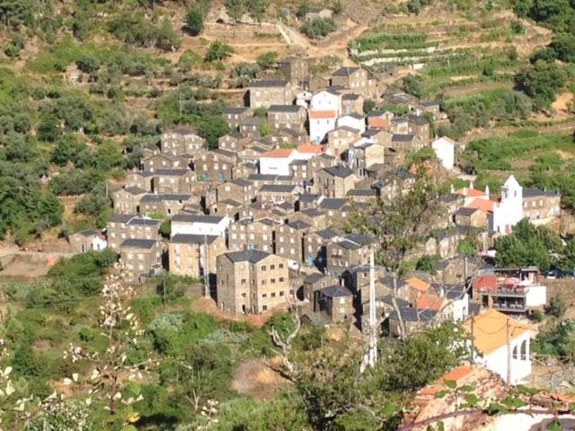a town on top of a hill with buildings at Casa da Encosta - Piódão in Piódão