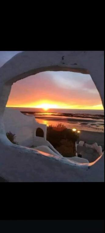 a view of a sunset through a window of a boat at Complejo FE LE SA in Las Grutas