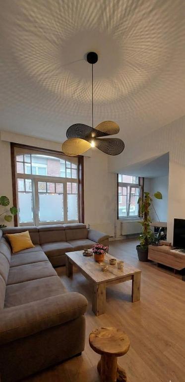 a living room with a couch and a table at Peaceful Pad in Brussels