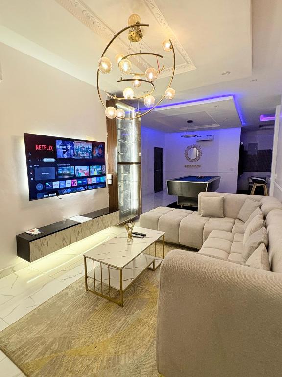a large living room with a couch and a table at Candy horizon height Apartemnt in Ikate