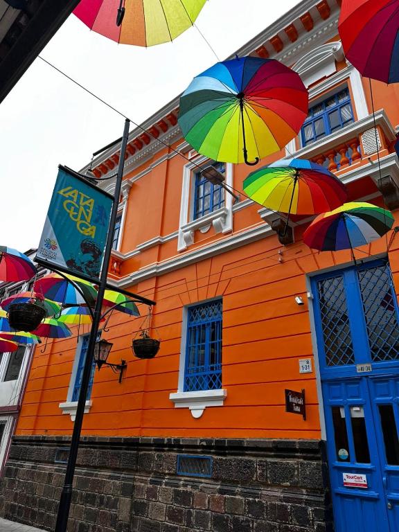 a group of colorful umbrellas in front of a building at Hostal Café Tiana in Latacunga