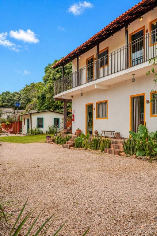 a house with a gravel driveway in front of it at Sabiá Hospedagem - São Jorge in Sao Jorge
