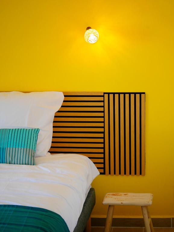 a bedroom with a bed and a clock on the wall at Petite Ancre in Le Gosier