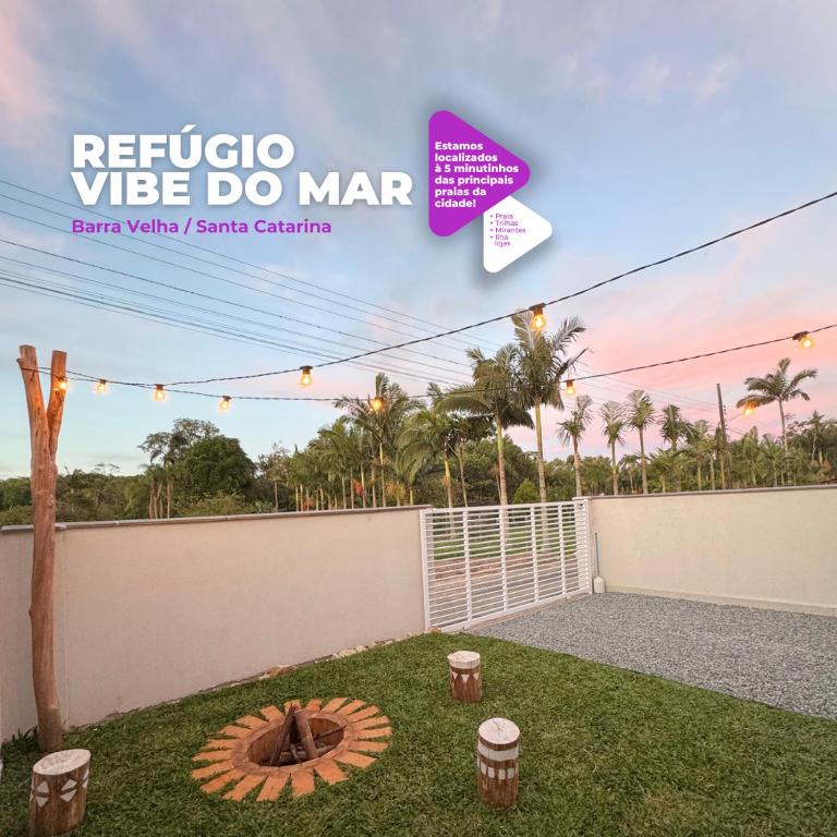 a backyard with a fire pit in the grass at Refúgio Vibe do Mar in Barra Velha