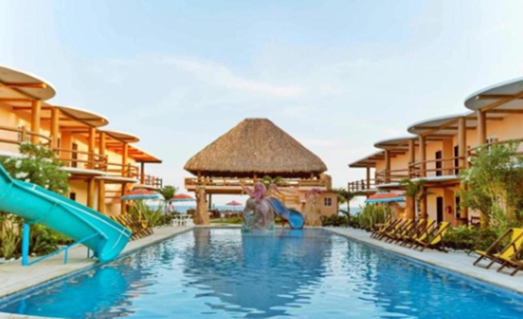 a woman in the water at a resort pool at Hotel Pazifico en Monterrico in Monterrico