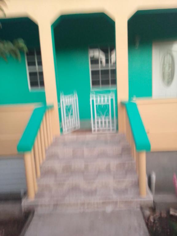 a house with two chairs sitting on the front porch at Carol Resident in The Grove
