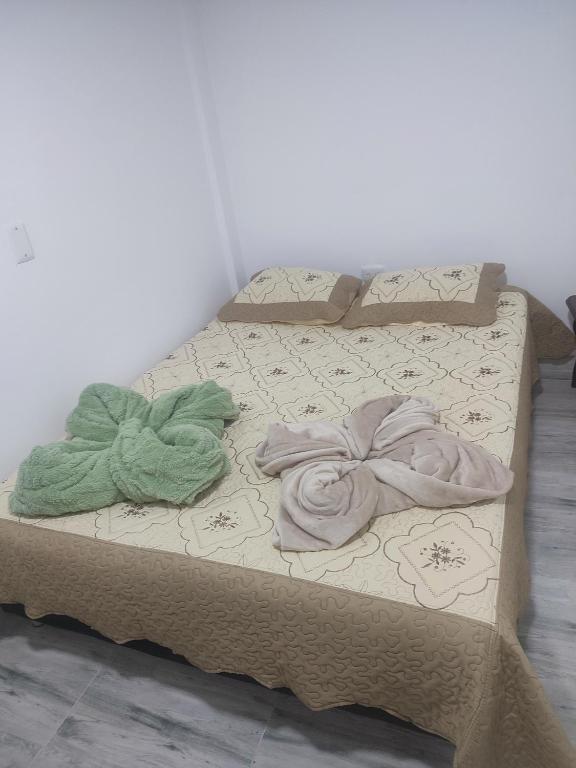 a bed with two blankets on top of it at Donde poyito in Sevilla