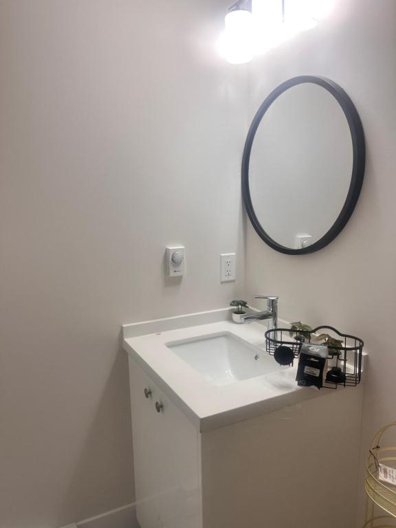 a bathroom with a white sink and a mirror at Peace House in Bills Island