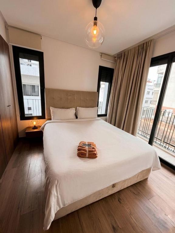 a bedroom with a bed with a towel on it at Diyafa Invest in Oulad Akkou